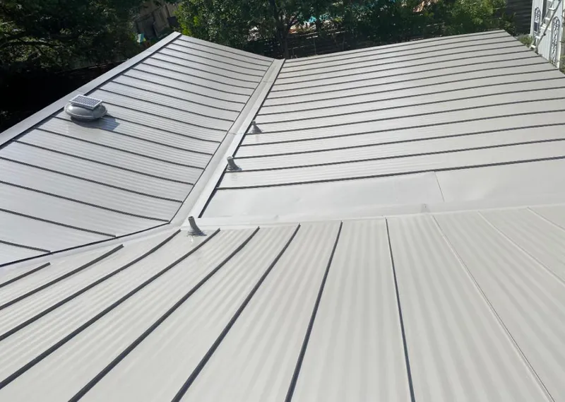 Solar attic fan installed on a metal roof for Roof Ventilation in Waimea